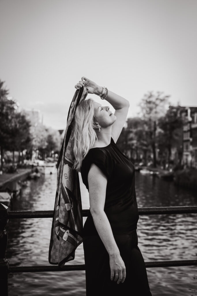 Julia headshot in Amsterdam, natural light photoshoot, model in Amsterdam, elegant style, black and white photography, Amsterdam canal